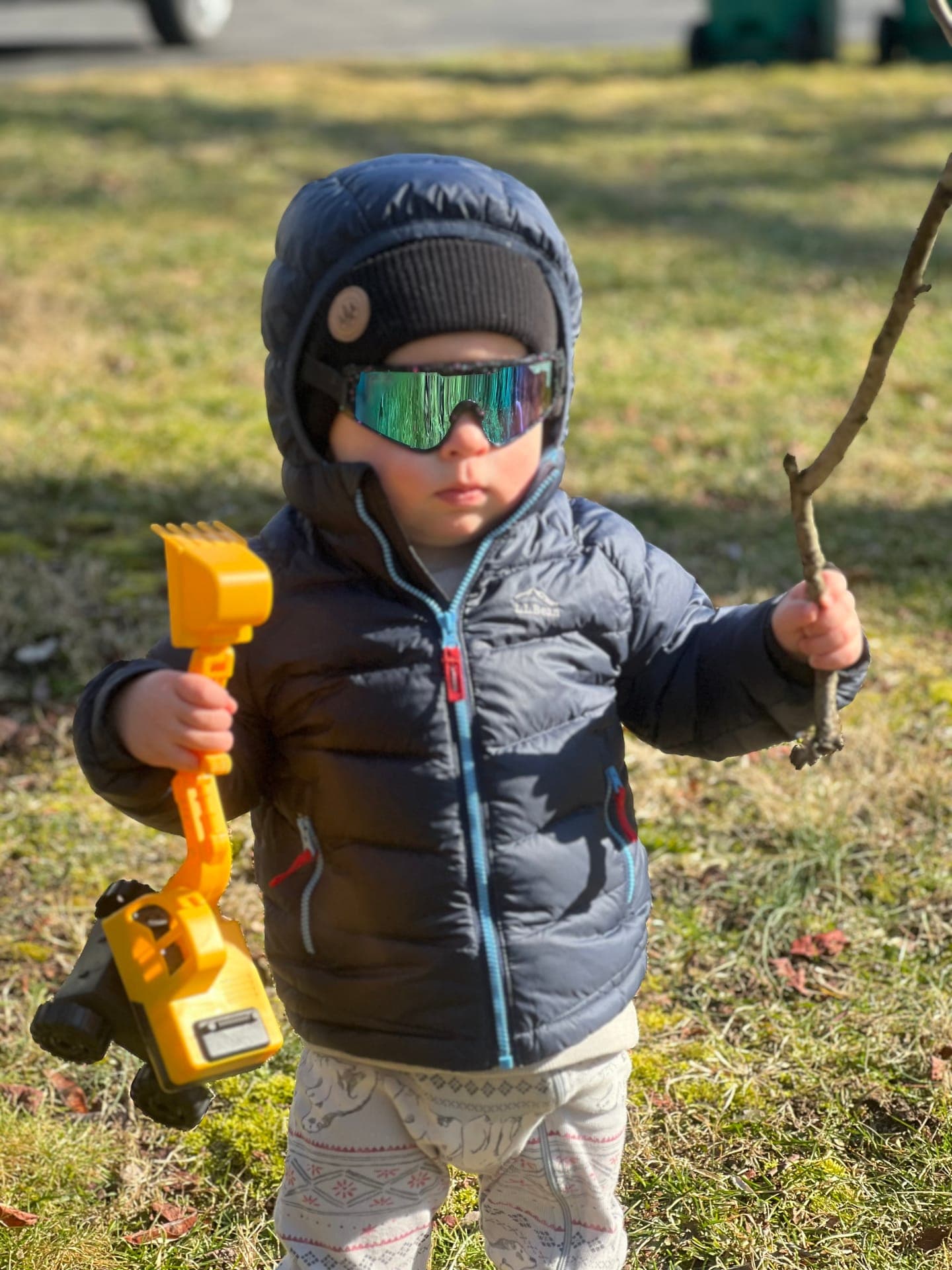 Young helper in safety glasses holding a cordless drill