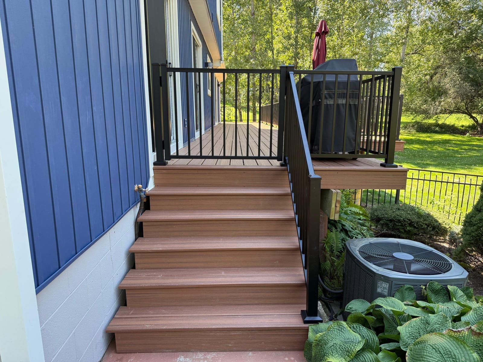 Finished composite deck stairs with aluminum railing